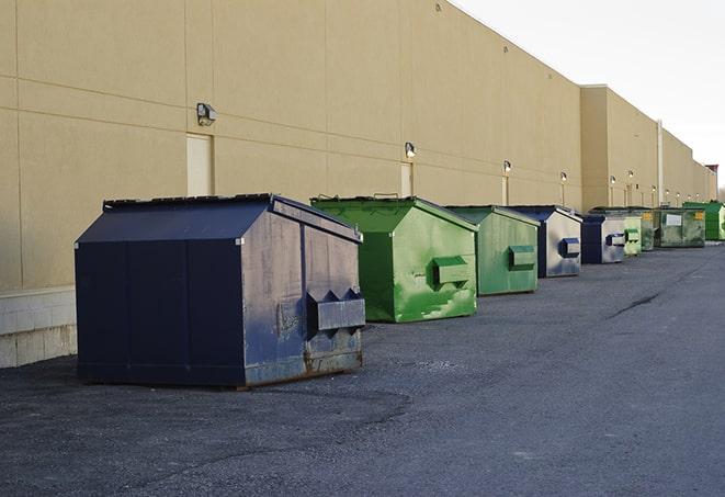 a pile of rugged and heavy-duty dump containers ready for construction waste in Berlin Center